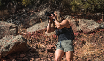 Woman taking photos in the woods