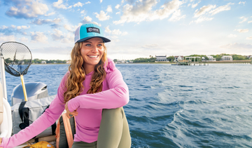 woman-on-boat-in-pink-sun-protection-hoodie