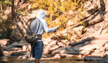 Man wearing Vapor Apparel hoodie while fishing